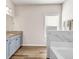 This bathroom features double sinks, marble countertops, and a tiled soaking tub at 7884 Rock Rose Ln, Fairburn, GA 30213