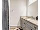 Bathroom with a granite countertop vanity and grey cabinets at 7884 Rock Rose Ln, Fairburn, GA 30213