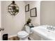 Stylish powder room features a pedestal sink and decorative shelving at 7884 Rock Rose Ln, Fairburn, GA 30213