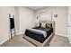 A cozy bedroom features a large bed, two sconces, and easy access to an ensuite at 7884 Rock Rose Ln, Fairburn, GA 30213