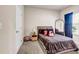 Cozy bedroom featuring a plush bed, full-length mirror, and neutral decor at 7884 Rock Rose Ln, Fairburn, GA 30213
