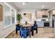 Bright dining area adjacent to the kitchen featuring a glass table, stylish chairs and large windows at 7884 Rock Rose Ln, Fairburn, GA 30213