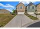 Traditional home featuring attached garages, paved driveways and manicured landscaping at 7884 Rock Rose Ln, Fairburn, GA 30213