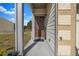Inviting front porch with a charming wreath on the front door and potted plants, creating a warm entrance at 7884 Rock Rose Ln, Fairburn, GA 30213