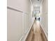 Bright hallway with hardwood floors and decorative wall panels that lead into the living area at 7884 Rock Rose Ln, Fairburn, GA 30213