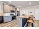 Stylish kitchen featuring gray cabinets, granite countertops, stainless steel appliances and island seating at 7884 Rock Rose Ln, Fairburn, GA 30213