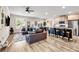Spacious open-concept living room with a modern kitchen, comfortable seating, and plenty of natural light at 7884 Rock Rose Ln, Fairburn, GA 30213