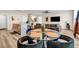Open-concept living space with dining area, kitchen island and comfortable sofa, perfect for entertaining at 7884 Rock Rose Ln, Fairburn, GA 30213