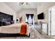 A spacious main bedroom features tray ceilings, a large window, and a decorative bed at 7884 Rock Rose Ln, Fairburn, GA 30213