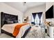 A well-lit main bedroom features tray ceilings, a large window, and a decorative bed at 7884 Rock Rose Ln, Fairburn, GA 30213