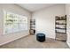 Office space with bright window light, a comfortable stool, and two modern bookshelves at 7884 Rock Rose Ln, Fairburn, GA 30213