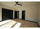 Bedroom with light wood floors, black door trim, and a ceiling fan at 1921 Herbert Dr, Tucker, GA 30084