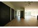 Spacious hallway with light hardwood floors and dark trim, with elegant light fixtures at 1921 Herbert Dr, Tucker, GA 30084
