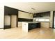 Modern kitchen with a large island, sleek cabinetry, and hardwood floors at 1921 Herbert Dr, Tucker, GA 30084