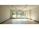 Sunlit living room featuring a modern chandelier, large windows, and hardwood floors at 1921 Herbert Dr, Tucker, GA 30084