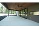 Expansive covered patio with wood ceiling, ceiling fans, and sliding glass doors to backyard at 1921 Herbert Dr, Tucker, GA 30084