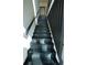 Contemporary black staircase with wood handrail and trim at 1921 Herbert Dr, Tucker, GA 30084