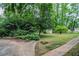Lush backyard with mature trees, green grass, and small storage shed at 2529 Habersham Dr, Decatur, GA 30032
