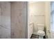 Updated bathroom featuring stylish marble tile shower, modern toilet, and vanity at 2529 Habersham Dr, Decatur, GA 30032