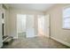 A cozy bedroom featuring neutral walls, carpet flooring, and multiple entry doors at 2529 Habersham Dr, Decatur, GA 30032