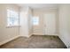 A cozy bedroom featuring two windows, a closet, neutral walls, and carpet flooring at 2529 Habersham Dr, Decatur, GA 30032