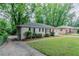 A cozy single-story home, complemented by a well-manicured lawn and mature trees at 2529 Habersham Dr, Decatur, GA 30032