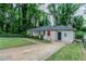 A charming single-story home with a lush green lawn and a welcoming red door at 2529 Habersham Dr, Decatur, GA 30032