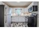 Modern kitchen features white cabinets, stainless steel appliances, unique backsplash and dark floor at 2529 Habersham Dr, Decatur, GA 30032