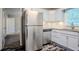 Modern kitchen boasts white cabinets, stainless steel appliances, and a stylish backsplash at 2529 Habersham Dr, Decatur, GA 30032