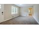 A bright living room with neutral walls, large window, and new carpet flooring at 2529 Habersham Dr, Decatur, GA 30032