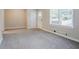 Spacious living room featuring neutral walls, large window for natural light, and carpet flooring at 2529 Habersham Dr, Decatur, GA 30032