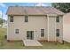 A two-story tan house featuring a sliding glass door and a small concrete patio at 4405 Feather Way, Douglasville, GA 30135
