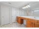 Bathroom features a large mirror, double sink vanity, and wood cabinets at 4405 Feather Way, Douglasville, GA 30135