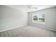 Neutral bedroom with a ceiling fan, window with blinds, and light gray walls and carpet at 4405 Feather Way, Douglasville, GA 30135