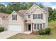 Charming two-story home with neutral siding, black shutters, and a two-car garage at 4405 Feather Way, Douglasville, GA 30135