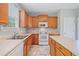 Functional kitchen with an island, white appliances, and neutral countertops and cabinets at 4405 Feather Way, Douglasville, GA 30135