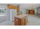 Spacious eat-in kitchen adjacent to the living room, featuring an island and white appliances at 4405 Feather Way, Douglasville, GA 30135