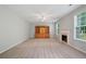 Carpeted living room with a fireplace, built-in shelving, and lots of natural light at 4405 Feather Way, Douglasville, GA 30135