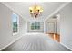 Bright living room with large windows, carpet, chandelier and fresh, neutral paint at 4405 Feather Way, Douglasville, GA 30135