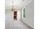 Spacious living room with carpet and fresh, neutral paint, looking into the kitchen at 4405 Feather Way, Douglasville, GA 30135
