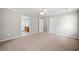 Neutral main bedroom with carpeted floor leads to an ensuite bathroom at 4405 Feather Way, Douglasville, GA 30135
