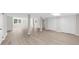 Large basement with updated flooring, featuring support beams and access to closet space at 7300 Wynhill Dr, Sandy Springs, GA 30328