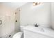 Modern bathroom featuring a tiled shower with glass enclosure and sleek white vanity at 7300 Wynhill Dr, Sandy Springs, GA 30328