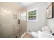 Clean, tiled shower room, next to a toilet, basin and a picture on the wall at 7300 Wynhill Dr, Sandy Springs, GA 30328