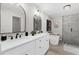 Modern bathroom featuring double vanity, soaking tub, glass shower, and sleek fixtures at 7300 Wynhill Dr, Sandy Springs, GA 30328