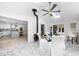 Bright, airy dining room, with kitchen in the background, features white walls, floors, and a round dining table at 7300 Wynhill Dr, Sandy Springs, GA 30328