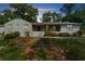 Charming brick home with a welcoming front porch and mature trees, perfect for outdoor relaxation at 7300 Wynhill Dr, Sandy Springs, GA 30328