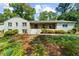 Charming brick home with a welcoming front porch and mature trees, perfect for outdoor relaxation at 7300 Wynhill Dr, Sandy Springs, GA 30328