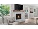 Cozy living room with fireplace, large window, and adjacent dining area at 7300 Wynhill Dr, Sandy Springs, GA 30328