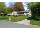 Well-manicured front lawn and covered porch, providing a welcoming entrance to this beautiful home at 7300 Wynhill Dr, Sandy Springs, GA 30328